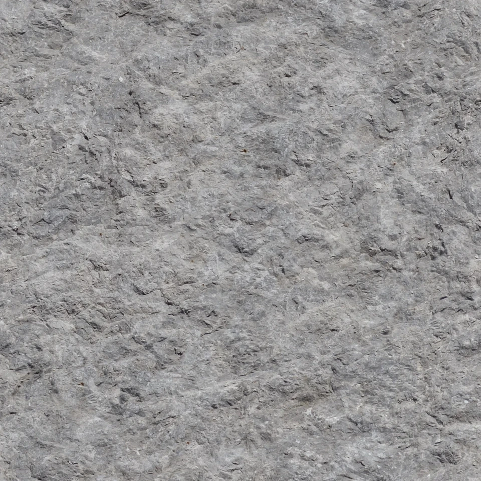 Detalle fotográfico del grano y relieve de una piedra de granito gris.